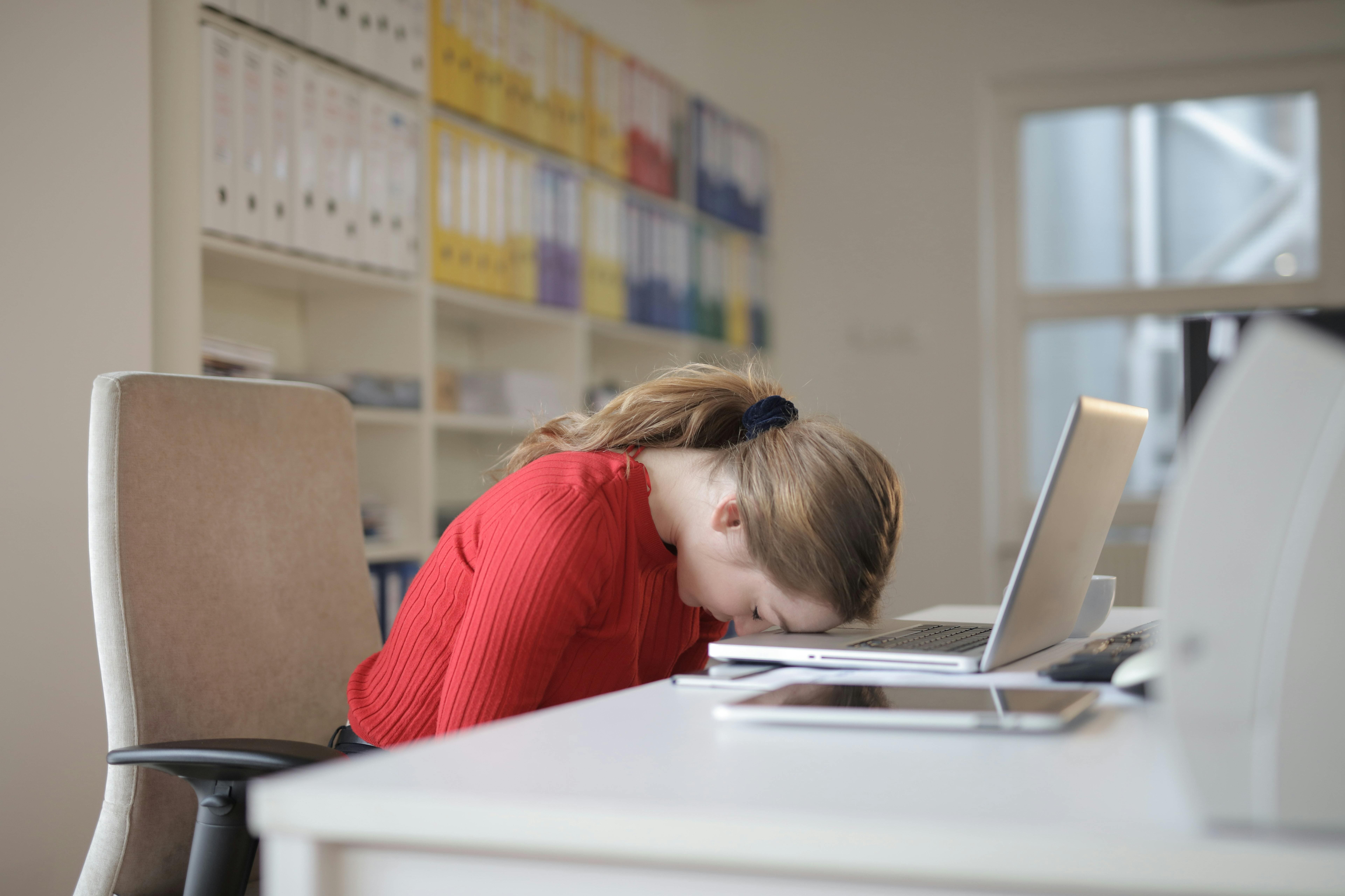 Lady laying head on table in frustration